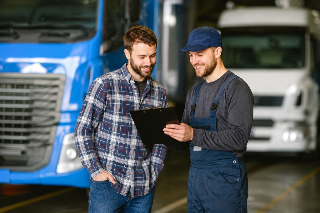 Neon Auto Transport logistics specialist conducting pre-transport vehicle condition inspection with customer in front of auto transport carrier trucks - licensed FMCSA broker USDOT 4355879
